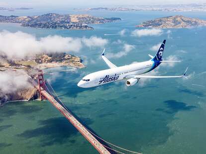 plane flying over golden gate bridge