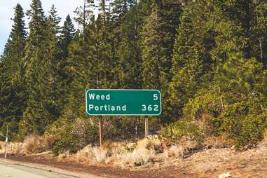 road sign that reads "weed" 