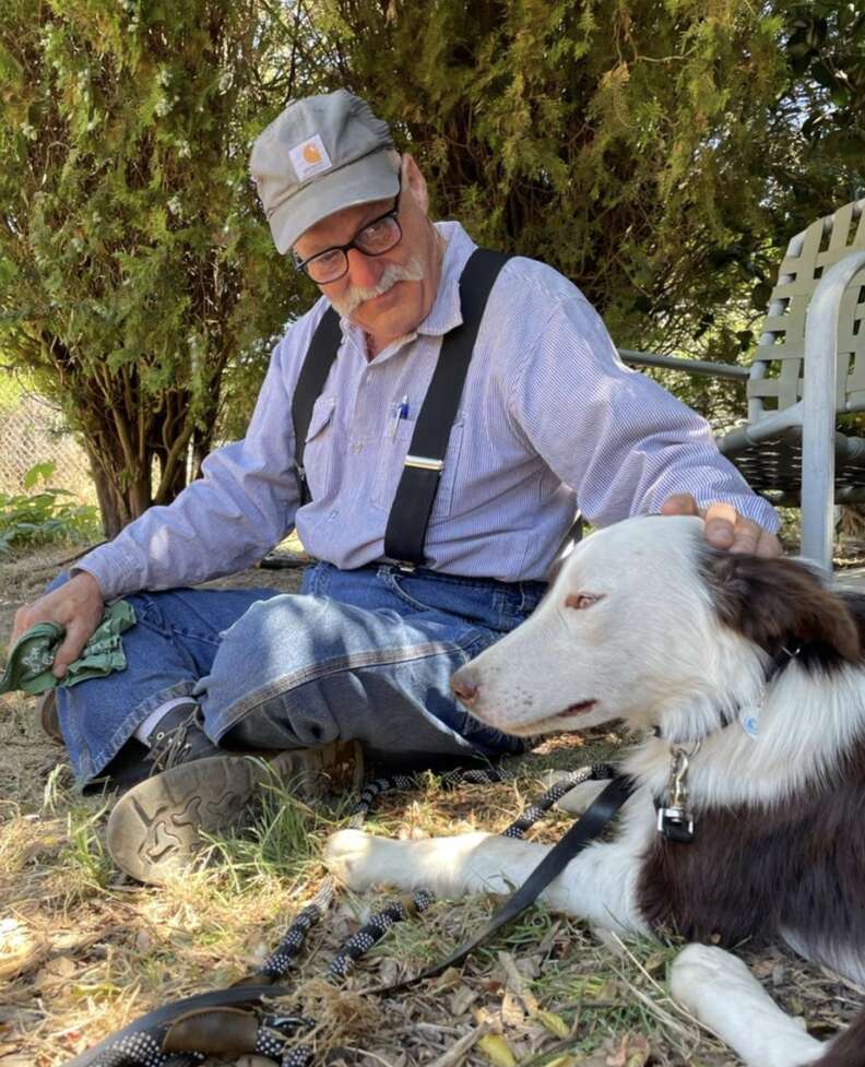 A man pets a do he rescued.