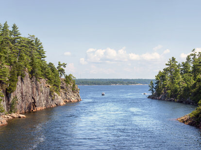 people jump from rocks into the water