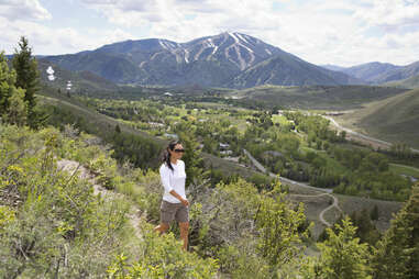 woman walking on mountain path 