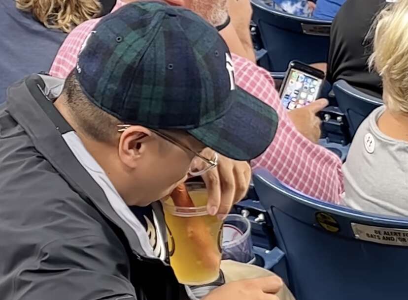 MLB fans both revolted and impressed as Yankees supporter uses HOT DOG as a  straw to drink his beer in viral video