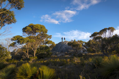 people standing on rock