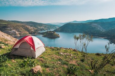 tent on cliff above water