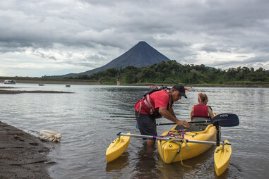 people preparing a kayak