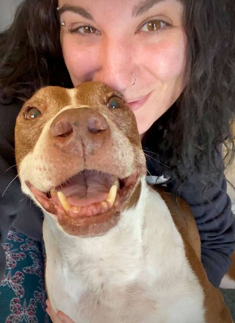 Happy dog is held by Mom.