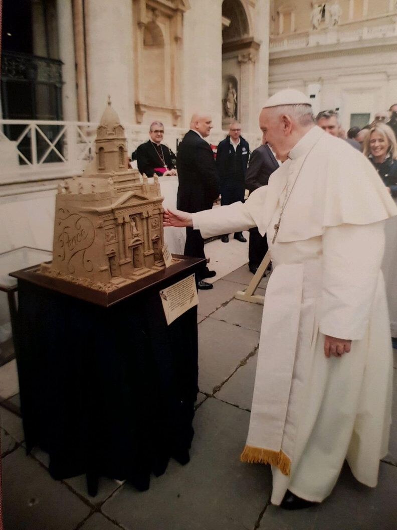 the pope and a sand sculpture