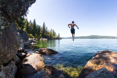 young man jumping of a rocky cliff