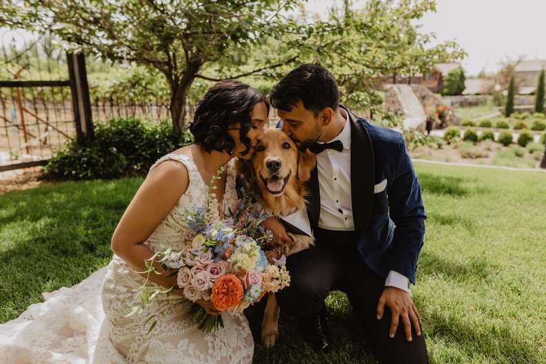 couple kissing dog 