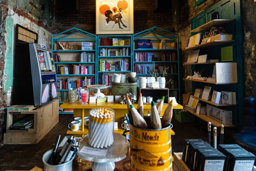 Cozy bookstore, shelves brimming with books under the warm library lights