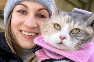 woman and her cat wearing winter gear