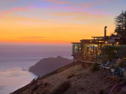 building on edge of cliff over water