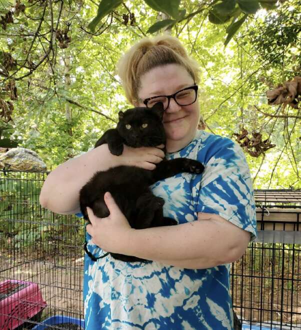 woman hugging cat 