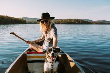woman and dog in canoe