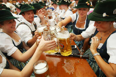 people cheersing in traditional german dress 
