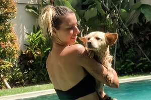 woman holding her dog in the pool