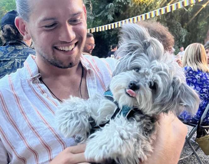 man holding dog 