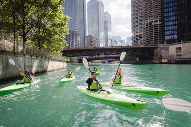 people kayaking through city