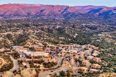 town tucked into mountains during sunset