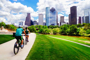 People riding bikes on paved trail in Houston Park