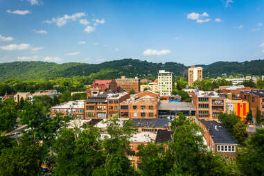 a city tucked into forested mountains