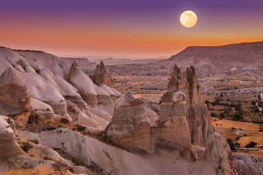 Full moon over rocky valley