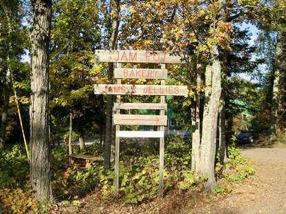 sign to jam pot in forested road
