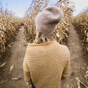woman in sweater in corn maze