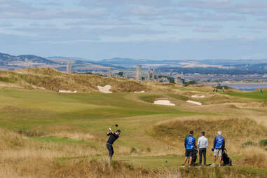 Men golfing at the Castle Course in St Andrews Scotland