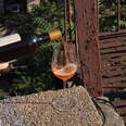 orange wine poured into wine glass 