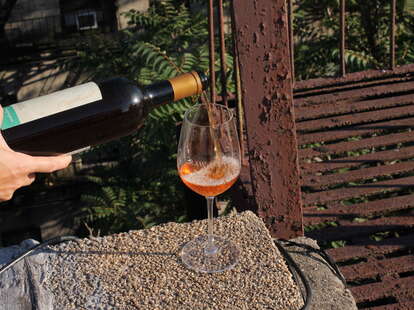 orange wine poured into wine glass