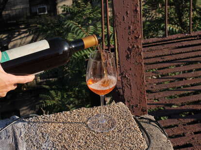 orange wine poured into wine glass 