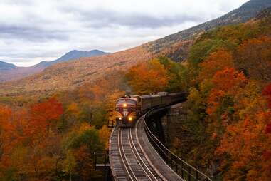 a train coming along a track with mountains in the distance