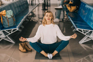 woman meditating in airport