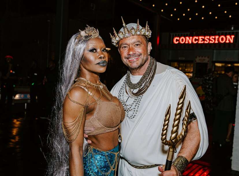 Fans dressed in Halloween costume watch play between the Atlanta