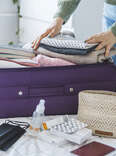 person packing a suitcase
