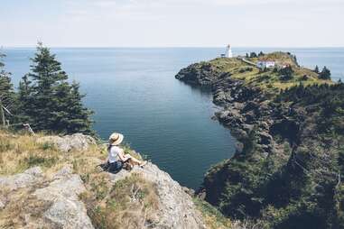 person sitting on cliff