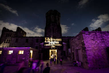 Eastern State Penitentiary at night, with Halloween Nights projected on the walls