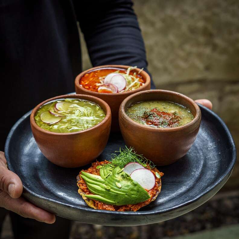 person holding salsas and soup