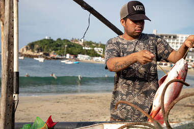 fisherman holding fish