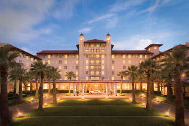 exterior of grand galvez surrounded by palm trees, galveston, texas