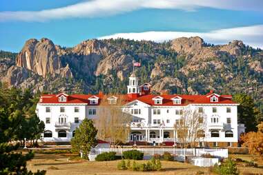 panoramic view of stanley hotel with rocky mountains background