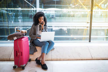 female traveler on her laptop at the airport