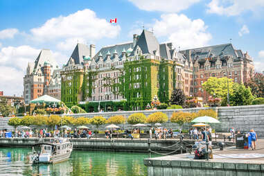 an opulent building and ships along a riverbank