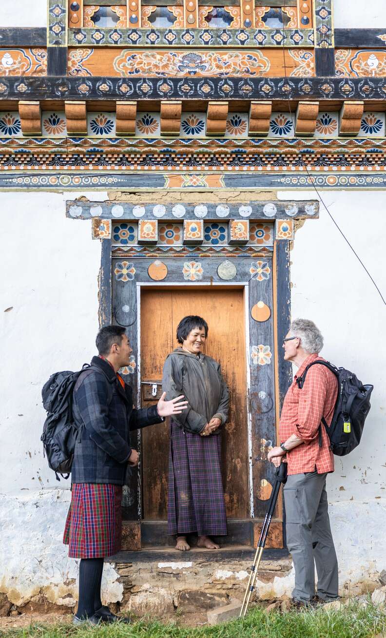 people standing outside house on trail