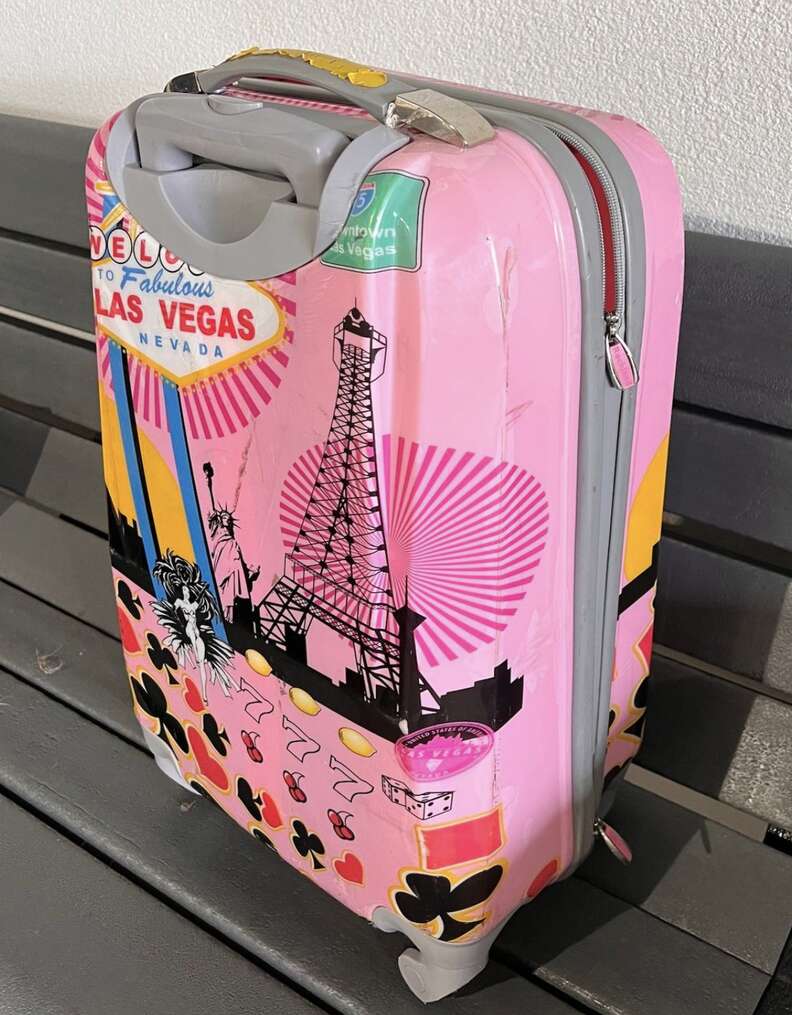 A lone pink suitcase.