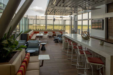 Hightop tables and banquettes in the airy Delta Sky Lounge