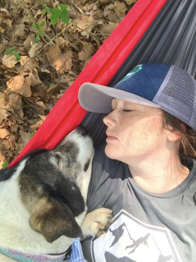 dog and woman in hammock