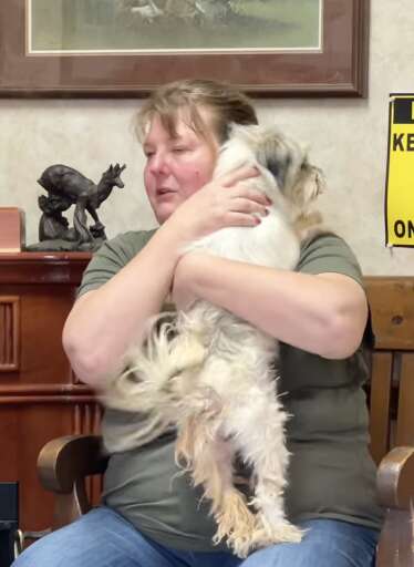 A woman reunites with her lost dog.