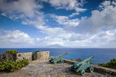 cannons in fort ruins with view towards St. Kitts Island
